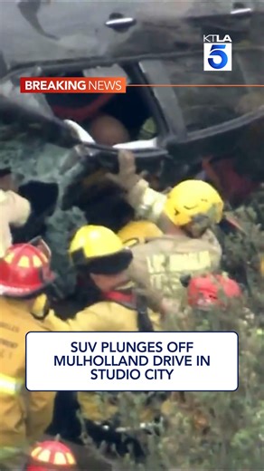 A dramatic helicopter rescue unfolded on live television Wednesday morning after a black SUV plunged roughly 100 to 150 feet off Mulholland Drive in Studio City. Full story: https://ktla.com/news/local-news/suv-plunges-off-mulholland-drive-in-studio-city-woman-hoisted-to-trauma-center/ | KTLA 5 News