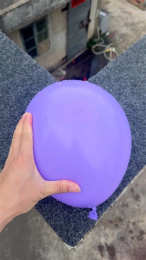 Experiment: Will a water balloon explode if it rolls down a tall building? 💥🎈 #balloon