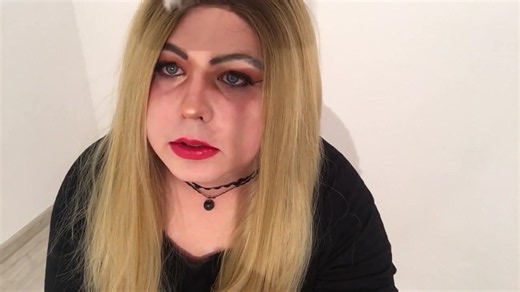 Blond sissy smokes a cigarette and plays with knob in chastity