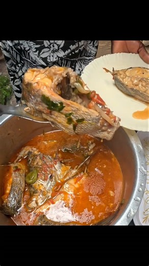 serving a big Nile perch in African village