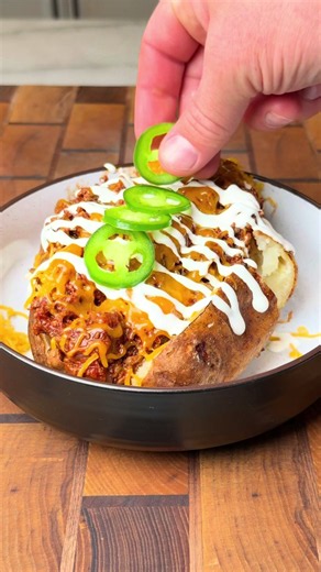 Brisket Chili Cheese Loaded Potato This is one of my favorite ways to eat chili! Recipe • Trim a brisket then season with SPG • Insert the @MEATER Pro to watch the internal temp while the brisket smokes. • Smoke the brisket on the @traegergrills at 250F for 8 hours. • Wrap the brisket when it reaches an internal temp of 175F. • Place it back on the smoker until it reaches 203F internal. Let it rest for 3 hours, then slice it against the grain. • Brown 2 lbs of ground beef in a Dutch oven then re