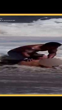 A lifeguard in California rushed in to rescue a swimmer caught in powerful waves.