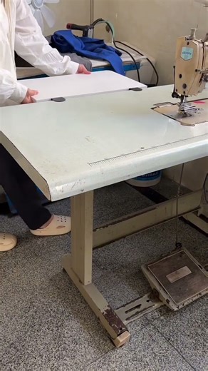 Sewing machine extension table. "Clothing factory" making clothes.