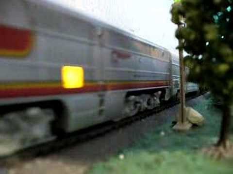 Santa Fe passenger train passes a waiting freight train
