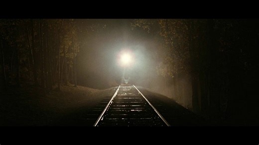 Cinematographer Roger Deakins had a camera platform with a soft buffer built on the railroad tracks so the train could run into it safely and push the camera down the track for this incredibly visceral shot. Movie Magic!