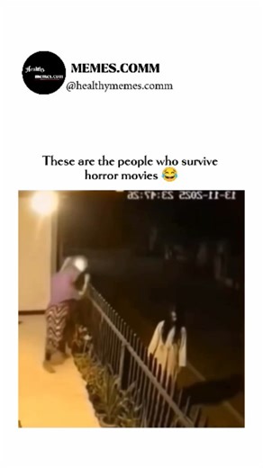 memes.comm on Instagram: "This video is a short, humorous clip captured by a night-vision security camera that plays on the cliché reactions of characters in horror movies. The scene takes place outside a house at night. A person dressed in a white gown with long black hair, resembling a ghost or a character from a popular horror movie like The Ring or The Grudge (often referred to as a Pontianak or Kuntilanak in Southeast Asian folklore), is seen standing motionless outside the railing. Suddenl