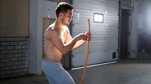 A man tuning national brazilian instrument berimbau