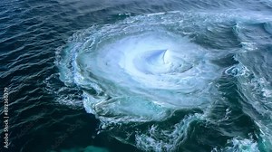 A dramatic ocean whirlpool swirling in the deep sea or ocean, showcasing the raw power and dynamic movement of water in nature