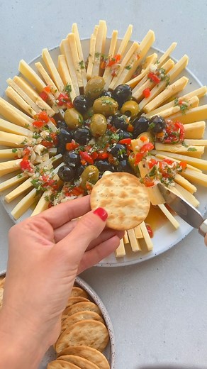 Check out this marinated cheese & olives appetizer. Made with two kinds of cheese served with olives marinated in garlic, herbs, roasted pepper, olive oil and vinegar. It’s such a unique, festive and delicious appetizer and a fun change from cheese boards! | Feel Good Foodie