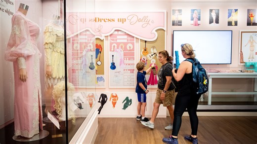 You can see Dolly Parton’s iconic rhinestone fashions on display now! But not for long
