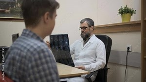Doctor Shows A X-Ray To A Patient. 4k