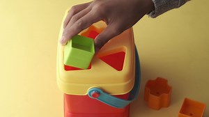 Child playing with geometric shaped toys