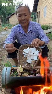 6.9M views · 10K reactions | #WhatToCook: The grandma cooked local cuisine, fish soup, in a bamboo tube harvested from Yaoshan Mountain, central China’s Hunan province. | People's Daily, China | Facebook