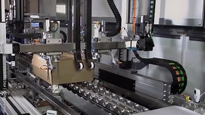 automatic packing machine. Robotic product packaging line. Automatic clothing packaging conveyor