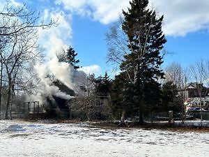 Two people in hospital, school evacuated as crews battle Dartmouth house fire