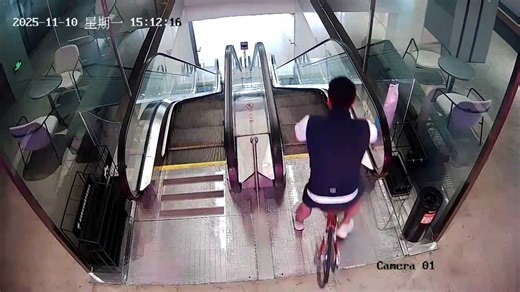 Foolhardy cyclist tumbles down escalator after attempting to ride bike down