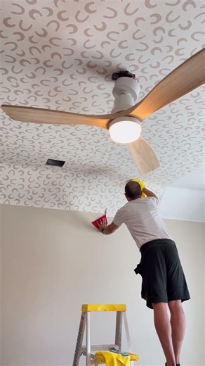 From careful alignment to final smoothing, this ceiling wallpaper install changes the entire space.