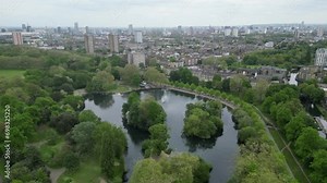 Aerial footage of the West Lake at Victoria Park with London skyline in the background in England