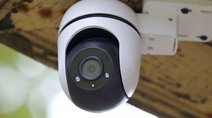 Security outdoor PTZ surveillance camera installed under the roof of the house. Pan tilt zoom camera provide HD view zoom and 360 rotation for full security coverage.