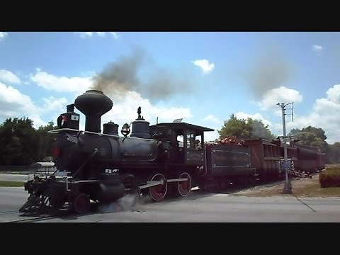 Steam Train Passing Through Crossing