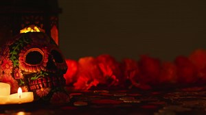 Still Life Of Decorated Skull With Candles And Flowers Celebrating Mexican Holiday Of Dia De Muertos Or Day Of The Dead | Free Stock Video Footage