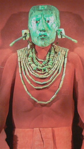 At least 1300 years old, this funerary mask is attributed to the Maya culture of Palenque and comes from the tomb of K’inich Janaab’ Pakal, an ancient ruler of Palenque, in present-day Chiapas, Mexico. It is made of jade, shell, and obsidian, originally composed of over 340 jade tesserae in at least six shades of green (about 200 remain), with shell applications and obsidian discs forming the eyes. The mask measures 24 cm (9 7/16 in) in height and includes a T-shaped amulet in the mouth. This ar