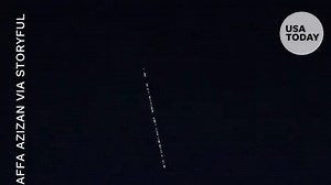 Satellites in train formation shoot across night sky