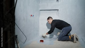 applying insulation to the concrete floor using a trowel