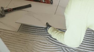 Phoenix, Arizona, AZ, USA.9.23.24. A tiler is installing ceramic tiles in a house.