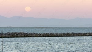 Full Moon Setting Fraser River 4K UHD. The moon setting over Steveston Harbor. Richmond, British Columbia, Canada. 4K UHD.