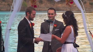Caucasian groom and bride reading the vows to each other during the wedding event