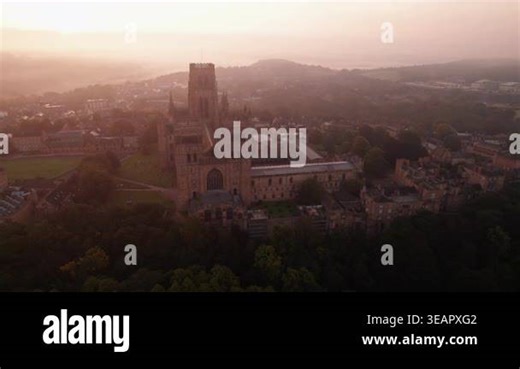 Drone tracks around the facade of Durham Cathedral on a beautiful, misty summer dawn. Low fog is seen in the town Stock Video Footage - Alamy