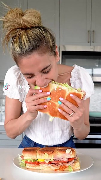 It's summer, stop making boring sandwiches! @itsmycheatday is stacking up a Grinder Salad Sandwich with layers of turkey, ham, melty cheese, crisp lettuce, tangy peppers, creamy dressing, tomatoes, and avocado - all tucked into a toasted roll. Crunchy. Creamy. Cheesy.