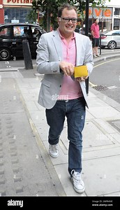 Radio host and comedian Alan Carr cheerfully arrives to BBC Radio 2 studio to broadcast his Saturday night radio program. London, UK. 07/03/10 Stock Photo - Alamy