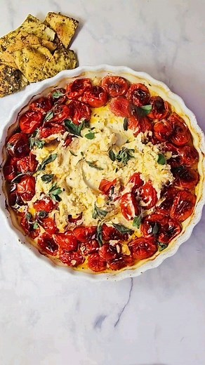 Boursin Tomato Dip. Warm, full of flavor, and so satisfying - this cheesy dip is loaded with goodness 🙌 - 2 cups of cherry or grape tomatoes - 1 Boursin Garlic and Herb cheese - 2 garlic cloves, sliced thin - 1/4 tsp salt - 1 tsp dried oregano leaves - 1/2 tsp red pepper flakes - 2 tbsp olive oil - a handful of fresh oregano leaves - optional Preheat the oven to 400 degrees. Lay the tomatoes on a baking dish. Slice the garlic and sprinkle over the tomatoes. Drizzle with the olive oil, salt, dry
