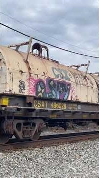 Heavy duty equipment on a csx manifest with a blue tanker car