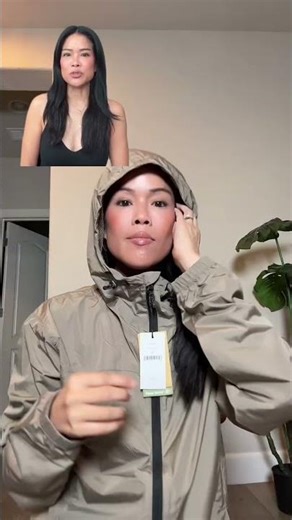 Water repellent windbreaker with a full-zip closure, fixed hood, pouch pocket, and lightweight