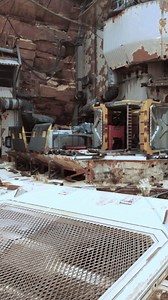 An abandoned building covered in rust and decay