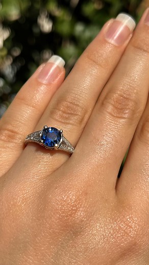 A delightful Bohemian-blue sapphire glows from the epicentre of this beautiful ring. Beneath the sapphire on either side, a round brilliant cut diamond twinkles brightly and scroll designs flow down the sides. The shoulders of the ring have been set with smaller diamonds that sparkle brilliantly in their v-tapered design that flows onto the band which has been hand-engraved with foliate patterns. Weight: 3,9 grams Blue Sapphire: 1.46cts Diamonds: 0.30cts in total (G-H)(VS-SI) Dimensions: 7mm - w