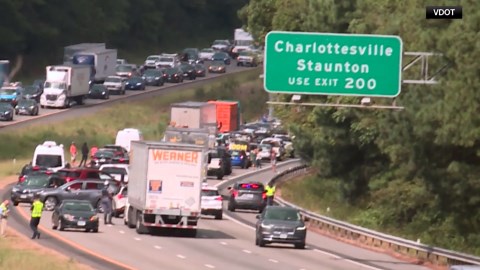 A highway accident leaves a truck trailer standing upright