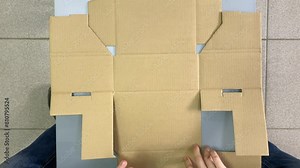 cardboard box. fold a cardboard box.assemble a cardboard box.cardboard box top view.Slow-motion video. High quality video in 4K format.