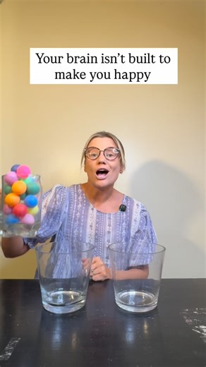 Millie | The Pocket Psychologist on Instagram: "Your brain isn’t built to make you happy It’s built to keep you alive 🧠 That’s why it clings to the one awkward moment The one thing you wish you’d said differently The one dark ball in the jar Your brain thinks threat spotting equals safety But zoom out The full jar matters The wins matter Getting through hard moments Not giving up Learning Regulating Keeping going That dark ball was a moment Not a verdict Not your identity Reality is much more g