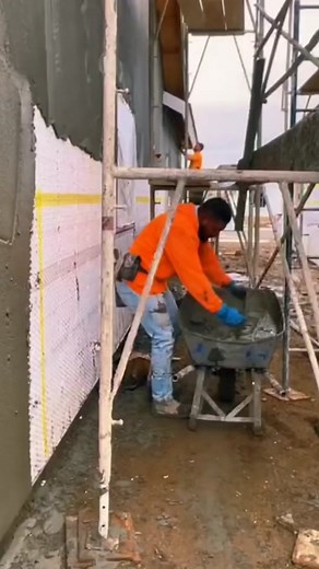 Construction Worker Handling Concrete on Job Site