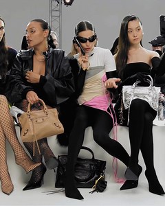 A staged Balenciaga runway presentation premieres the Le City bag campaign, revealing the handbag's maximalist silhouette and adaptable shoulder-to-crossbody functionality. The show’s atmosphere manifests through personalities Devon Lee Carlson, Pernille Teisbaek, Livia Nunes Marques, Camille Charriere, Justine Skye, Dixie D'Amelio, and Olympia of Greece joining models Sua Lee, Paloma Elsesser, and Mika Schneider, all captured in Lauren Greenfield's lens. Select sizes in stores or find the full 
