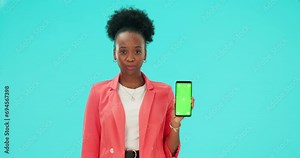 Confused face, phone and black woman with green screen in studio isolated on a blue background. Mobile, mockup space and person with doubt shrug, question and advertising tracking markers in portrait