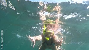 Woman swimming underwater. Girl plunges into the sea. Diving, woman dives and swims under water. Go-Pro video. Marine dive, active, bright impressions. Diving on the Black Sea.