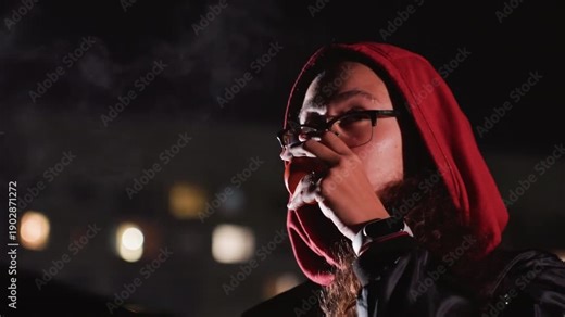night rooftop stargazer with red hood young woman in glasses sips warm cup while scanning sky with telescope, city lights blurred behind, breath visible in cold air, contemplative mood, science