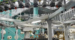 Industrial knitting machine producing cotton yarn