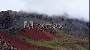 Peru Rainbow Mountain Vinicunca Montana de Colores 4K Drone_Slow Move and Boom up over hill to reveal mountains and clouds