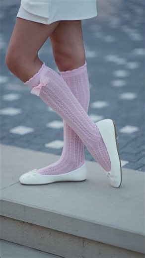 Young Girl in Pink Bow Socks and White Ballet Flats Standing Outdoors